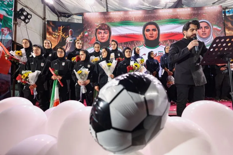 Between Celebration and Controversy: Iran's Female Footballers Return Home Under Regime Scrutiny